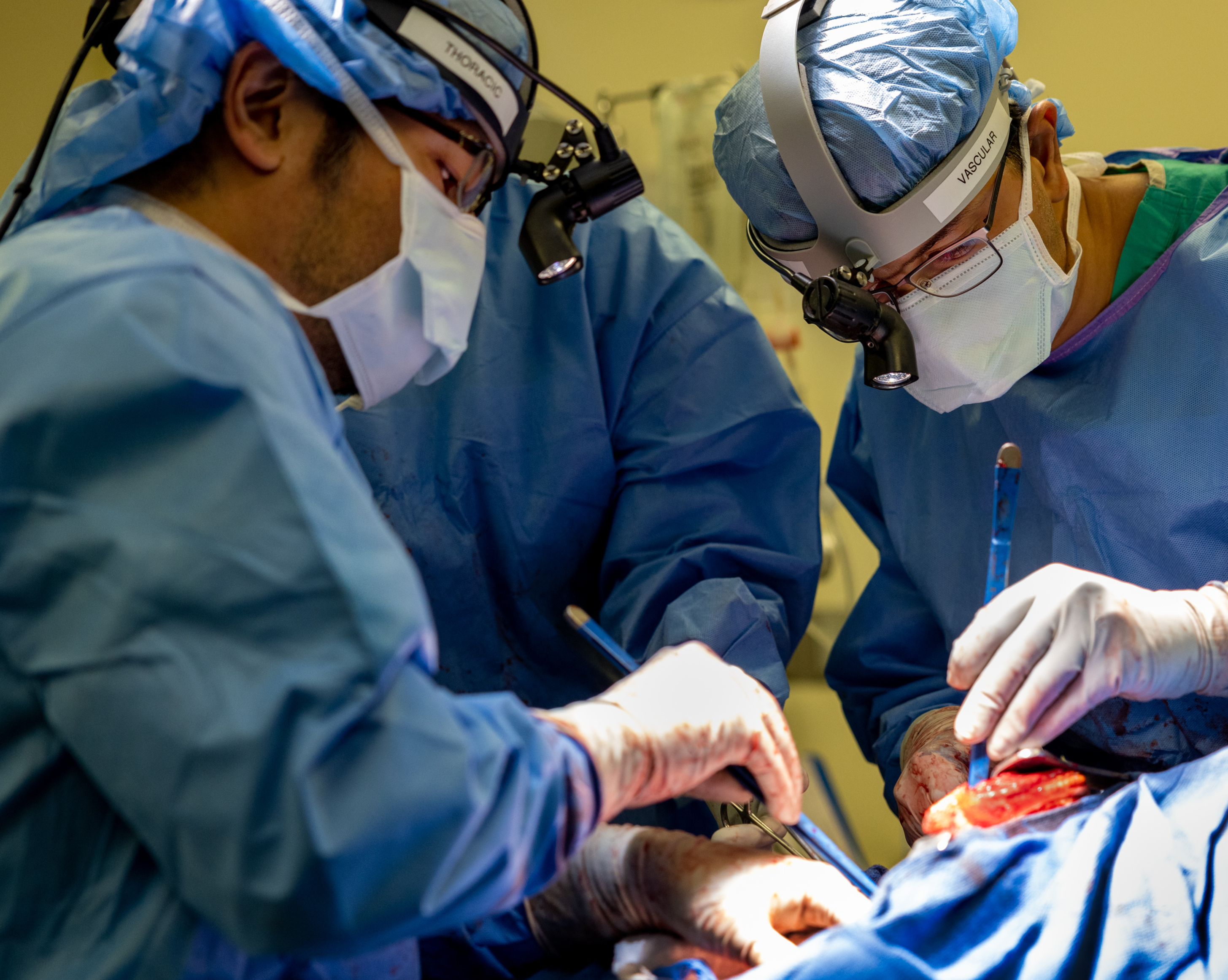Dr. Chitaru Kurihara (left) and Dr. Ankit Bharat (right) operating on a patient, removing the damaged lungs and attaching an artificial lung, prior to the transplant two days later.